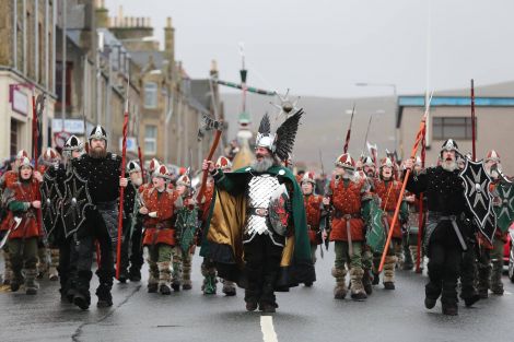 The Jarl's Squad, led by Neil Robertson, heading in over along Commercial Road in dreich conditions. Photo: Geoff Leask