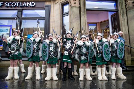 This year's junior squad of vikings, led by Guizer Jarl Lewis Harkness, in high spirits on Commercial Street. Photo: Craig Sim