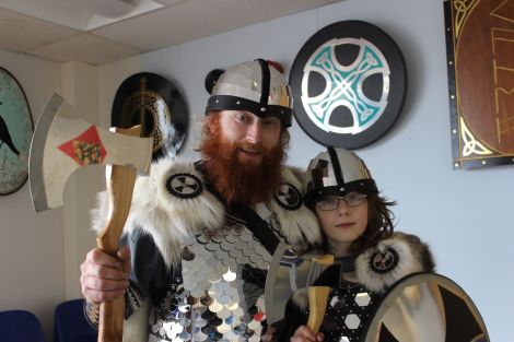 Guizer Jarl Alan Jamieson, aka Kveldulf Bjalfason, with his 11 year old eldest son Fraser at Brae primary department on Friday morning. Photo Shetnews