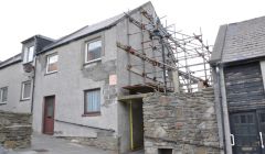 The property in Pitt Lane with scaffolding erected four years ago to support a bulging gable end. Photo Shetnews