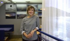 Self-taught photographer Floortje Robertson with her exhibited work in the Peerie Shop this week. Photo: Shetnews/Neil Riddell