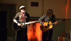 Dean Owens on stage at Muckle Roe Hall last night, with Arthur Nicholson - and a curious-looking fireplace - in the background.