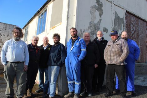 Just some of the Northmavine Up Helly Aa committee outside the galley shed they have spent thousands repairing doors, windows and roof. Photo Shetnews