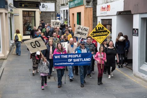 Around 50 people took part in a protest calling on Carmichael to resgin in Lerwick on Saturday afternoon. Photo: Austin Taylor