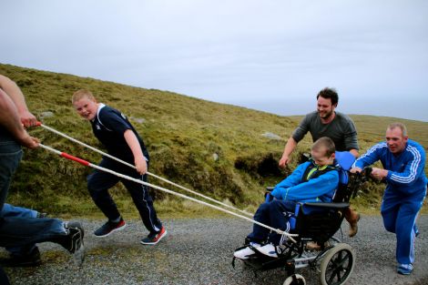 The team pushing and pulling him up the track.