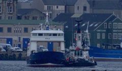 The harbour tug Knab is taken Fivla back to Lerwick - Photos: John Bateson