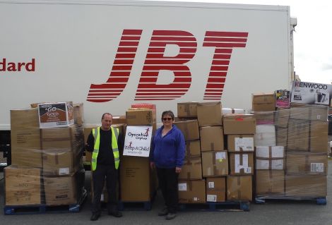 Julie Odie pictured with JBT's Tony Monaghan and the parcels bound for Moldova.