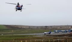 A Bristow helicopter takes off from Scatsta airport taking workers to the North Sea oil fields.