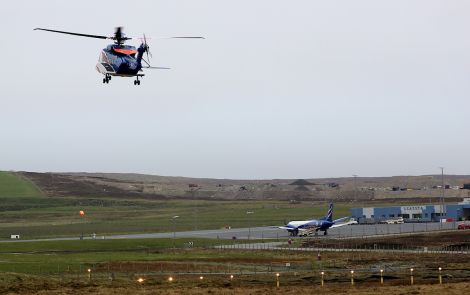 A Bristow helicopter takes off from Scatsta airport taking workers to the North Sea oil fields.