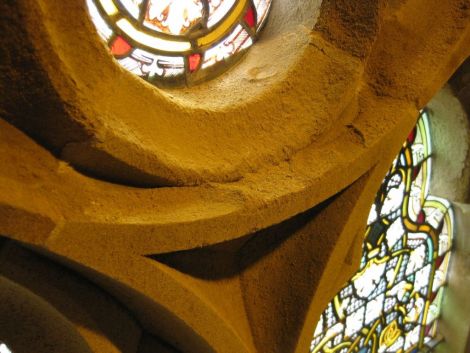 Crumbling sandstone around one of the main hall's many prestigious stained glass windows.