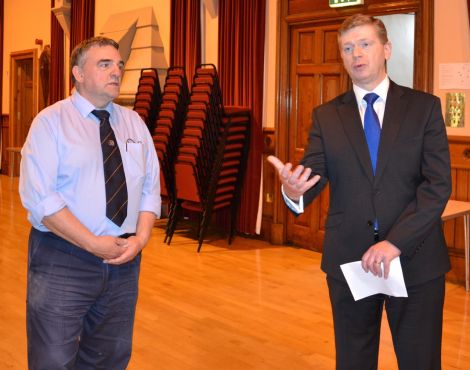 Town hall caretaker Billy Sandilands looks on as convener Malcolm Bell explains the extent of the damage. Photo: Shetnews