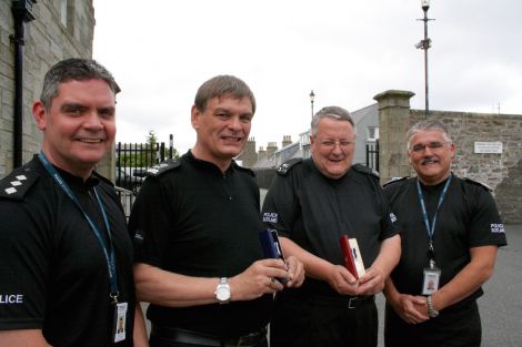 Special occasion. Shetland area commander Lindsay Tulloch (left) with retiring Barry Derbyshire and Peter Smith holding their medals with assistant chief constable Derek Robertson.