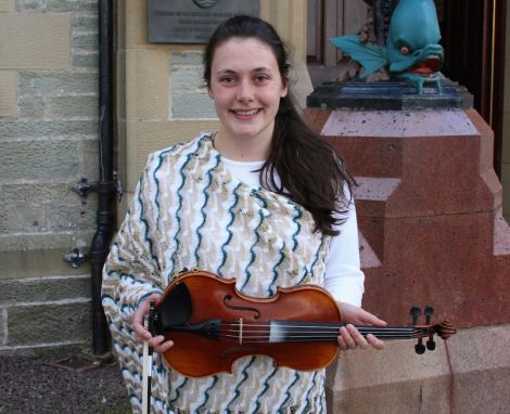 Fiddler Marjolein Robertson, one of around 70 heading for the Edinburgh Military Tattoo, sporting the special outfit designed for the occasion whose theme is "east meets west". Photo Shetnews