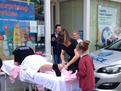 A policeman entering into the spirit by getting his legs waxed.