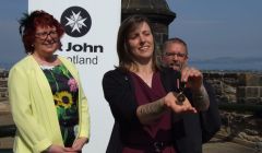 Proud parents Wynne and Derrick look on as Jessica shows off her medal at the Castle Esplanade in Edinburgh.