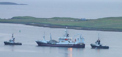 Resolute getting assistance from the harbour tugs this morning. Photo: Ian Leask