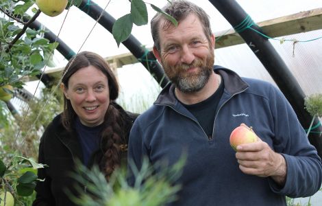 Enjoying some Shetland grown apples: Sue Hinton and Tom Jenkinson in one of their two poly clubs - Photos: Hans J Marter/ShetNews