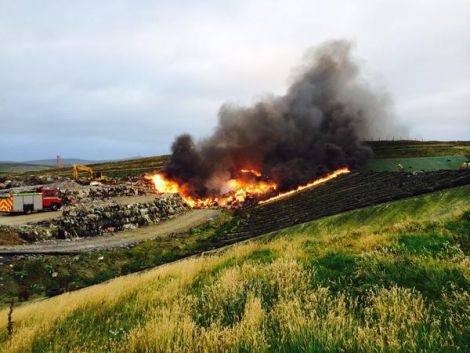 Smoke billows forth from the fire.