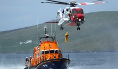 The coastguard helicopter is regularly seen exercising with Shetland's two life boats. Seen here is the Aith lifeboat, the Charles Lidbury - Photo: Bristow