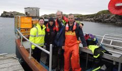 SSPCA auxiliary officer Terresa Leask, Jan and Pete Bevington from Hillswick Wildlife Sanctuary and Sean Williamson on board his creel boat Emeritus back at Bousta after rescuing the seal.