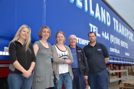 Kaila McCulloch, Emma Harmer and Rona Arthur from the Shetland Solidarity with Refugees group, along with Shetland Transport's Hamish Balfour and Raymond Stewart, after packing up the final pallet ahead of shipping donations to Inverness six weeks ago. Photo: Shetnews/Neil Riddell