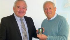 Head of laboratory services at NHS Shetland Geoff Day receiving the Ebola medal from chairman of NHS Shetland Ian Kinniburgh - Photo: NHS Shetland