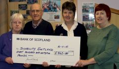 Laureen Fraser and James Smith of the Shetland ex-Whalers Association present the £862 cheque to Joyce Henderson and Eleanor Robertson of Disability Shetland.