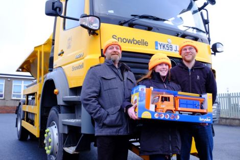 For her winning gritter name ‘Snowbelle’, Olivia Campbell (centre) from Bell's Brae Primary School received a model snowplough, goody bag and ‘gritter crew’ hat from councillors Michael Stout (left) and Steven Coutts. Photo: SIC