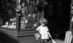 This image, by J. Peterson from 1938 showing a young girl at the door of E J Yates toy shop is one of the images that can be printed using the museum's new service