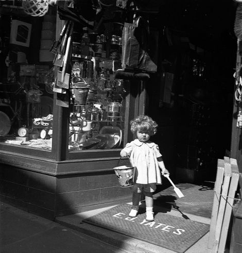 This image, by J. Peterson from 1938 showing a young girl at the door of E J Yates toy shop is one of the images that can be printed using the museum's new service