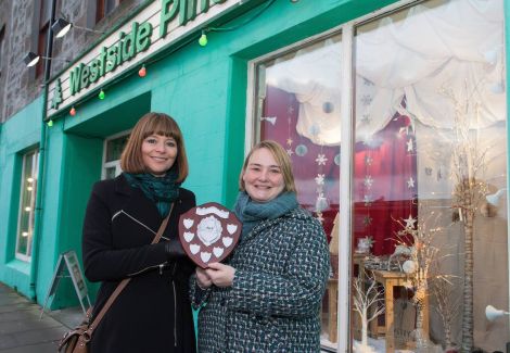 Marina Hunter of Westside Pine receiving the award from Living Lerwick's Cynthia Adamson.