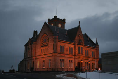 Midnight oil is being burned at Lerwick Town Hall aa councillors ands officials work out how to make extra savings after this week's shock of a 4.5 per cent cut to their government grant.