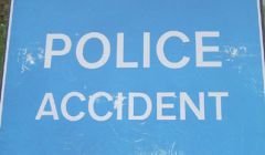 A blue and white police accident sign.