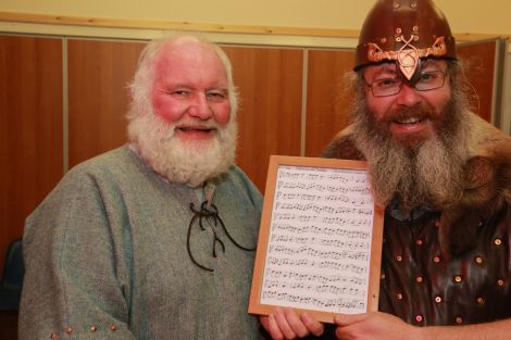 Squad member Peter Sinclair hands over the music for his freshly composed tune Thorir Hund's Two Step to a happy jarl. Photo Gordon Stove 