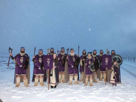 The bulk of the Cullivoe jarl squad line up on a snowy night.