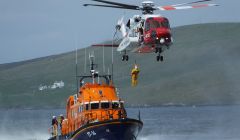 One of the Sumburgh based search and rescue helicopters exercising with the Aith lifeboat - Photo: Bristow Helicopters