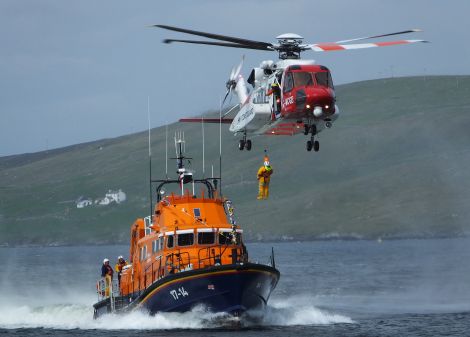 One of the Sumburgh based search and rescue helicopters exercising with the Aith lifeboat - Photo: Bristow Helicopters