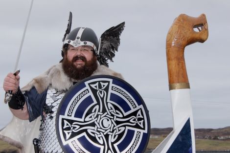 Delting guizer jarl Christopher Nicolson at the helm of his galley Stor Sjo. Photo Hans J Marter/Shetnews