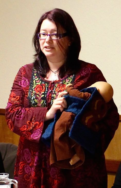 Helen Robertson using a doll with her daughter's clothes on as a symbol to demonstrate that girls can be part of an Up Helly Aa - Photo: Yetti Biscuit