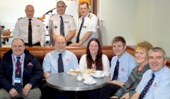 Enjoying the teas and home bakes are: (back row - left to right)) Hjaltland captain John Strathearn, hotel director Seamus Campbell, John Daly, purser; (front row - left to right): lifeboat mechanic Ian Harms, coxswain Bruce Leask, ladies' committee member Ann Marie Mullay, lifeboat crewman Ian Derbyshire, ladies' guild treasurer Rhoda Watt and lifeboat crewman Dieter Glaser - Photo: Jane Leask