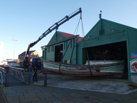 Being lifted into the museum's boat store to be refurbished. Photo Shetland Museum and Archives