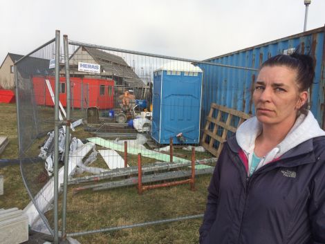 Mandie Fulbirg outside the building site surrounding her house on Stucco in Hillswick. Photo Shetnews