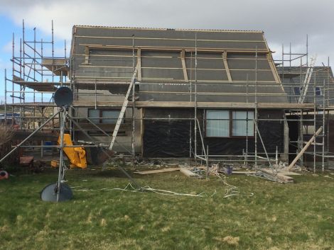 Walls, windows, roofs and doors are being replaced in the council properties while the tenants are living there.