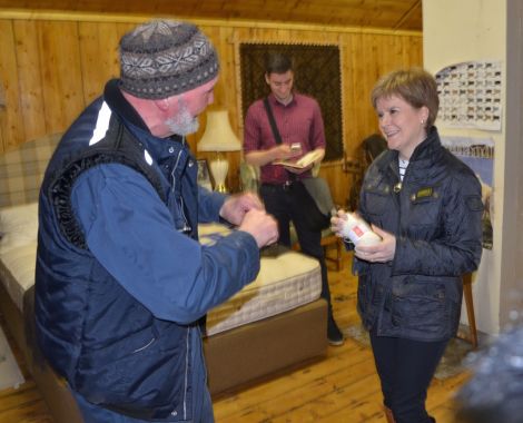 Nicola Sturgeon learning everything there is to know about wool from Jamieson & Smith's Oliver Henry on Monday afternoon. Photo: Shetnews/Neil Riddell