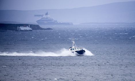 The Scalloway harbour pilot boat brings ashore the rescued crew of the yacht Miracle after being taken off the anchor handling vessel REM Gambler (in the background) which picked them up from a liferaft 50 miles south west of Shetland. Photo Chris Brown