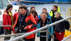 The Polish crew rescued from the yacht Miracle come ashore at Scalloway on Thursday evening, nine hours after escaping their blazing craft. Photo Chris Cope/Shetnews