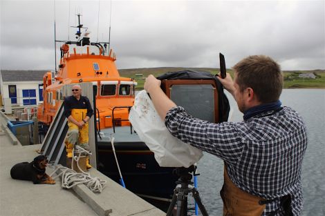 Jack Lowe preparing to capture Aith lifeboat coxswain Hylton Henry on glass.