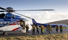 Offshore workers boarding a Bristow-operated helicopter at Scatsta Airport.