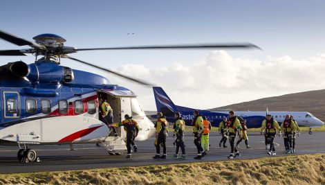 Offshore workers boarding a Bristow-operated helicopter at Scatsta Airport.