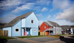 The Grodians scheme, next to the Baptist Church at Quoys, is one of two Richard Gibson Architects schemes to feature in a national exhibition. Photo courtesy of Hjaltland Housing Association